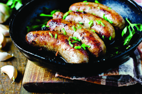 Homemade sausages fried in a frying pan